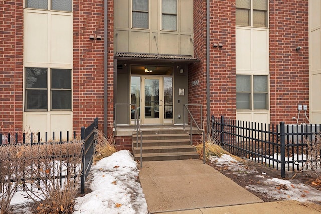 view of snow covered property entrance