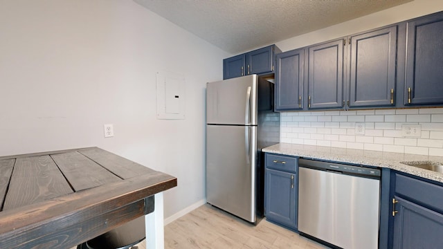 kitchen featuring blue cabinets, backsplash, electric panel, and appliances with stainless steel finishes