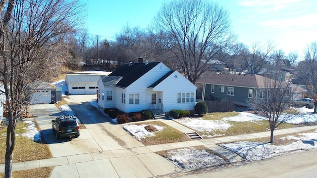 view of front facade featuring a garage, driveway, and a chimney