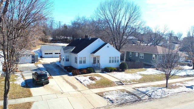 ranch-style home featuring a garage, driveway, a chimney, and fence