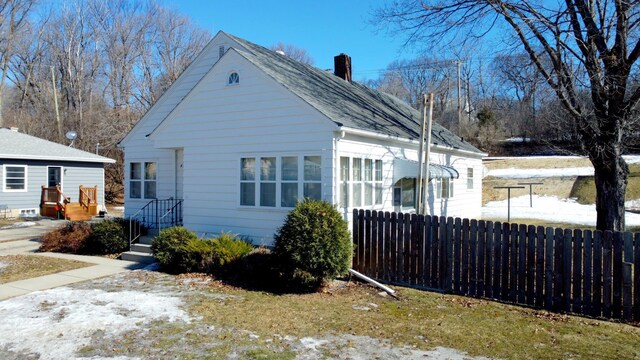 404 Vine St, Fergus Falls, MN 56537 - view of side of home with fence and a chimney
