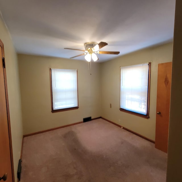 404 Vine St, Fergus Falls, MN 56537 - spare room featuring light colored carpet, ceiling fan, and baseboards