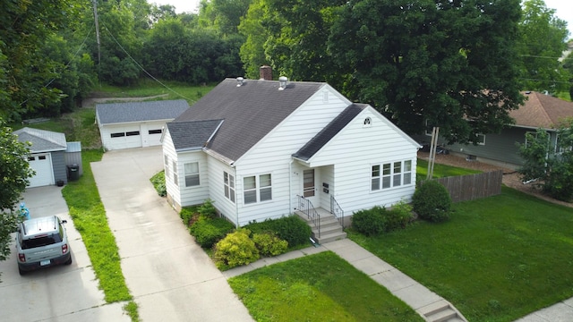 404 Vine St, Fergus Falls, MN 56537 - view of front of house featuring a shingled roof, an outbuilding, and a detached garage