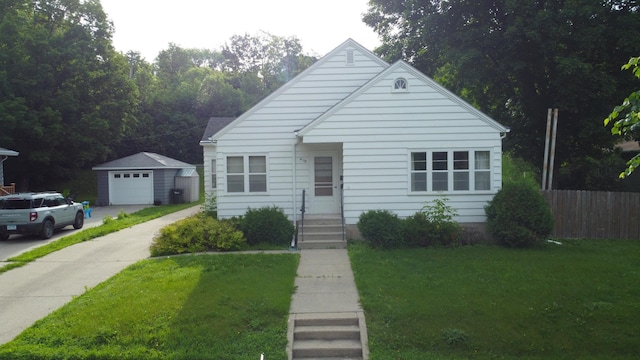 404 Vine St, Fergus Falls, MN 56537 - bungalow-style house with concrete driveway, a detached garage, and an outdoor structure
