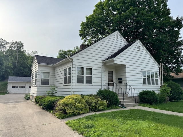 404 Vine St, Fergus Falls, MN 56537 - view of front of property featuring an outdoor structure, a chimney, and a detached garage