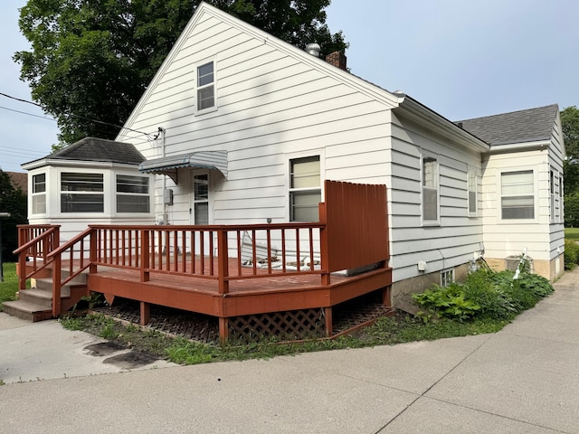 404 Vine St, Fergus Falls, MN 56537 - view of front of home featuring a wooden deck, a chimney, and roof with shingles