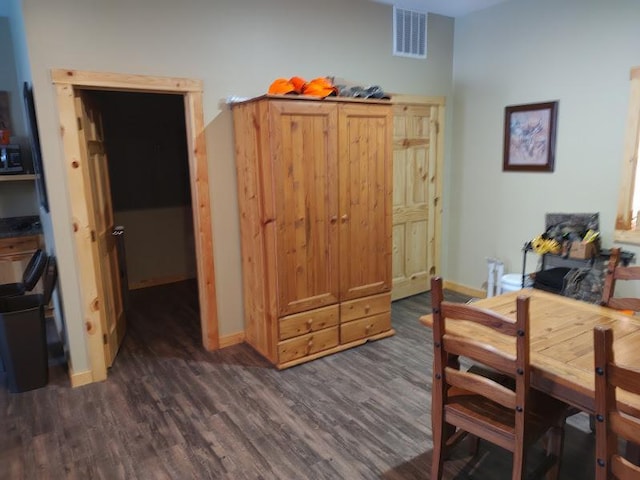 dining area with dark hardwood / wood-style flooring