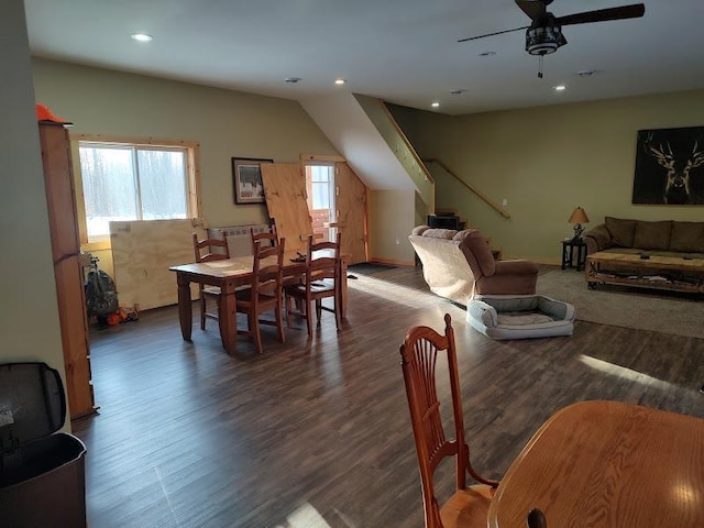 living room with ceiling fan and dark hardwood / wood-style flooring