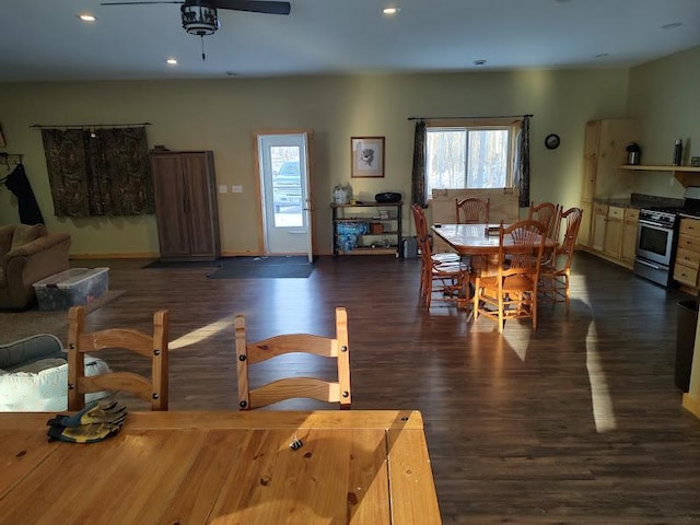 dining room with ceiling fan and dark hardwood / wood-style flooring