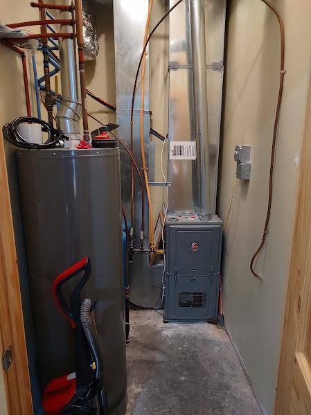 utilities featuring heating unit and gas water heater