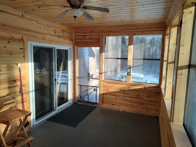 unfurnished sunroom with ceiling fan and wooden ceiling