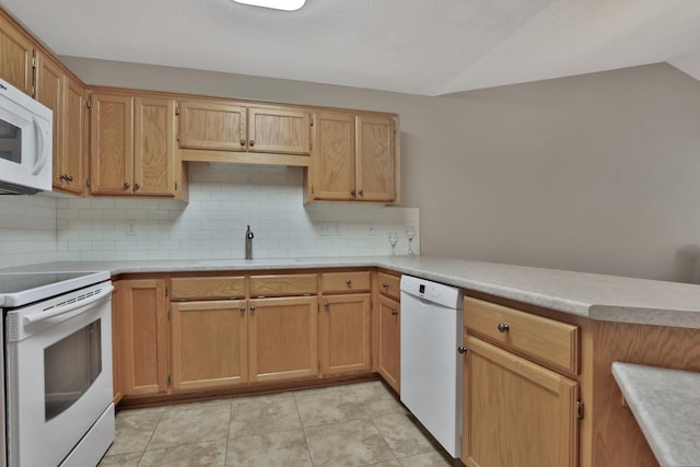 kitchen with white appliances, lofted ceiling, sink, backsplash, and kitchen peninsula