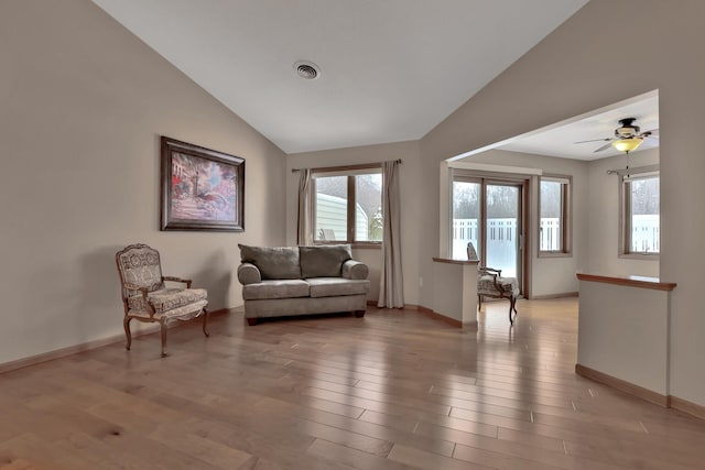 sitting room featuring ceiling fan, light wood-type flooring, and vaulted ceiling