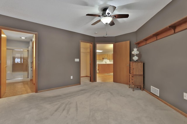 empty room with ceiling fan and light colored carpet