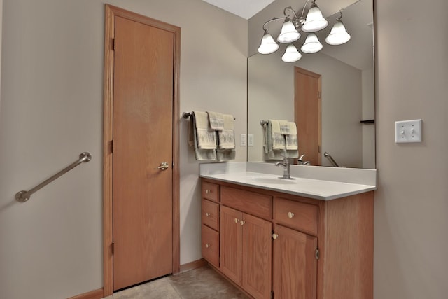 bathroom featuring vanity, a notable chandelier, and tile patterned flooring