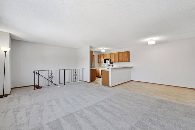 unfurnished living room with light carpet and a textured ceiling