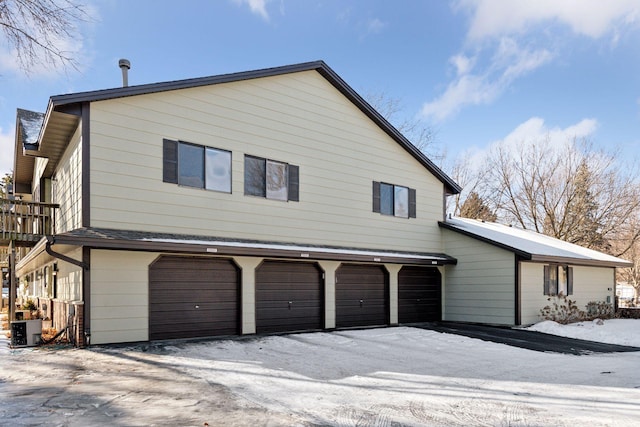 view of side of property with central AC and a garage