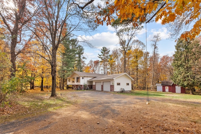 view of front of property with a storage shed and a garage