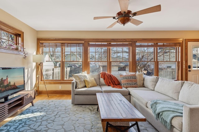 living room featuring ceiling fan and light wood-type flooring