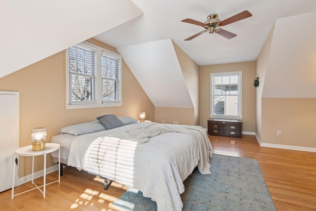 bedroom with hardwood / wood-style flooring, ceiling fan, and vaulted ceiling