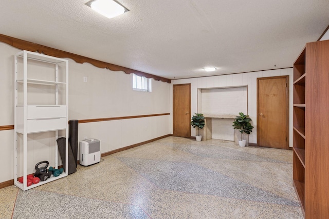 unfurnished room with a textured ceiling