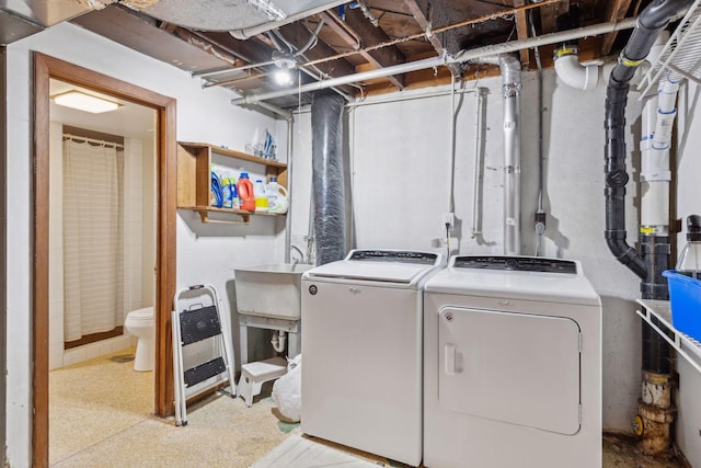 laundry area featuring washing machine and dryer and sink