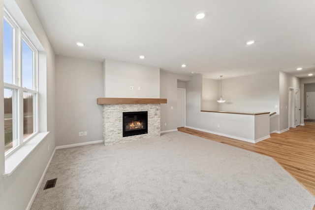 unfurnished living room with a fireplace and wood-type flooring