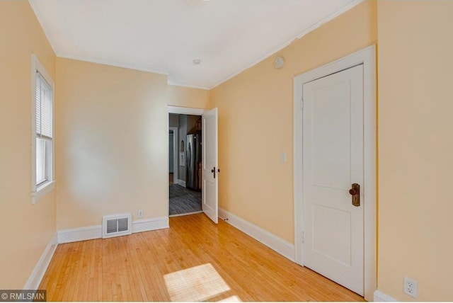 empty room with hardwood / wood-style floors