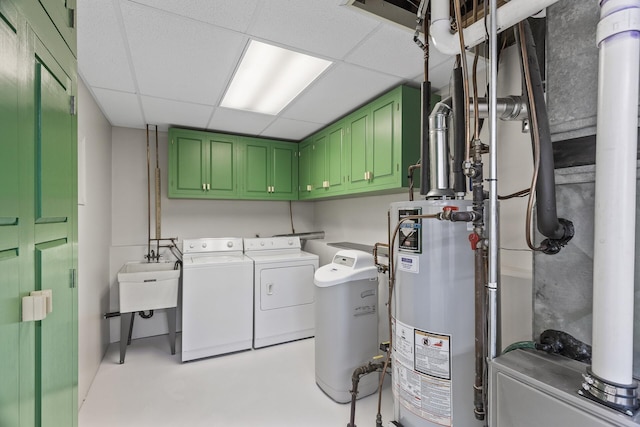 clothes washing area with cabinets, gas water heater, separate washer and dryer, and sink