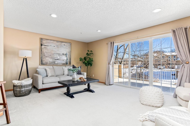 living room with carpet, a textured ceiling, baseboards, and recessed lighting