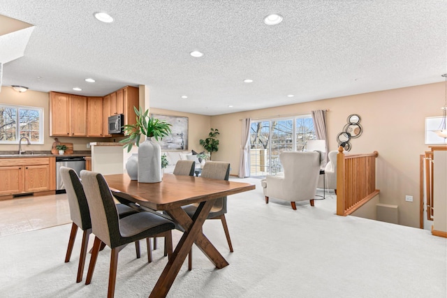 dining space with light carpet, plenty of natural light, a textured ceiling, and recessed lighting