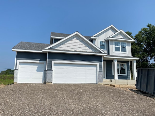 craftsman house featuring a porch and a garage