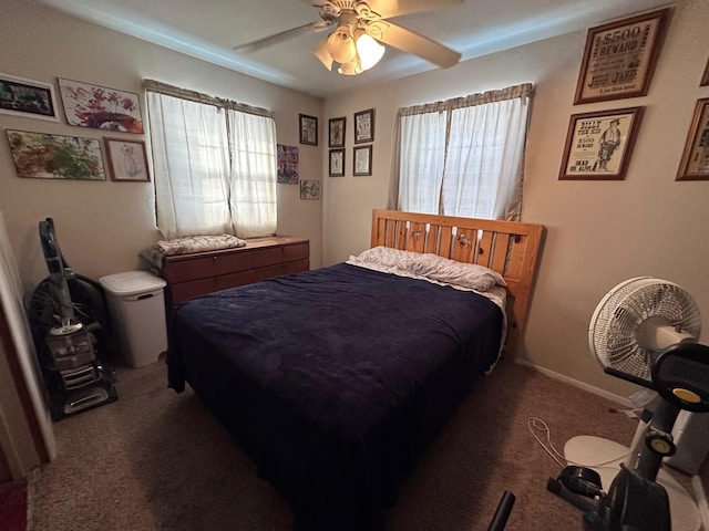 bedroom with ceiling fan and dark colored carpet