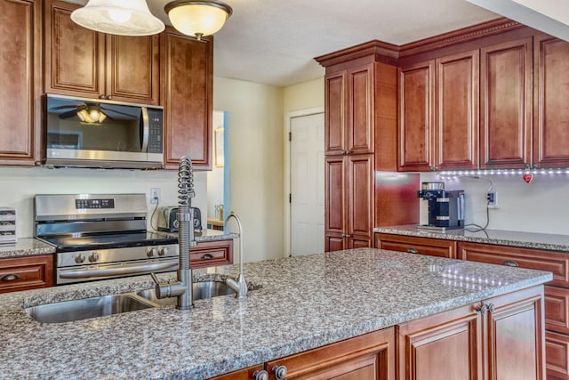 kitchen with light stone countertops and stainless steel appliances