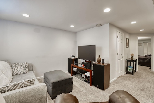 living room with recessed lighting, baseboards, and light colored carpet