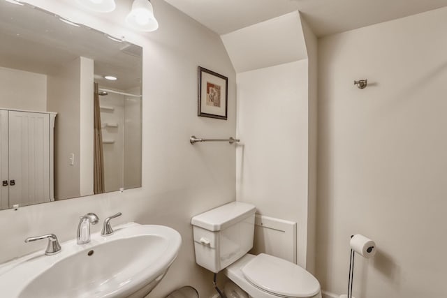 bathroom with a shower, a sink, and toilet