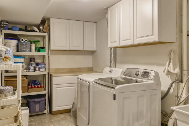 clothes washing area with cabinet space and washer and dryer