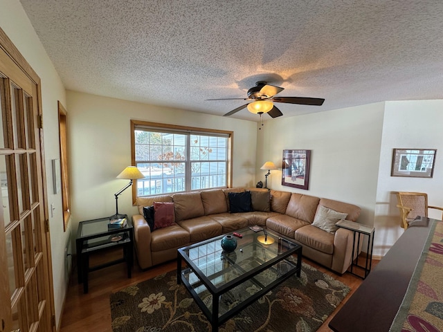 living room with ceiling fan, hardwood / wood-style floors, and a textured ceiling