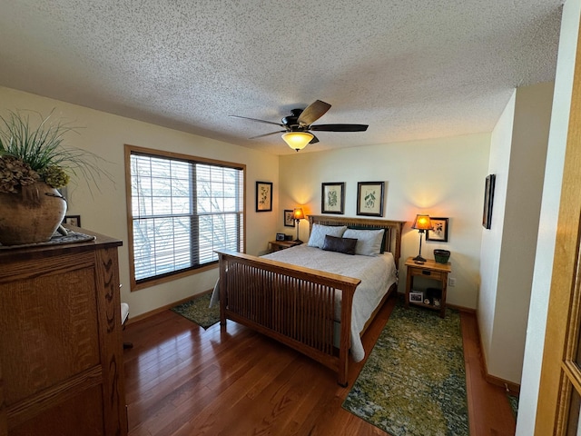 bedroom featuring ceiling fan, a textured ceiling, and dark hardwood / wood-style flooring