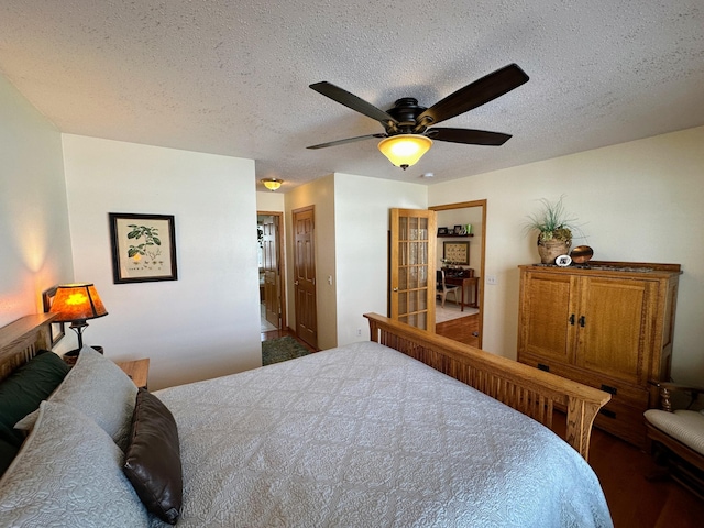 bedroom with ceiling fan and a textured ceiling