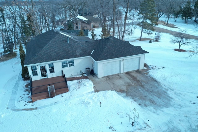 exterior space with central AC and a garage