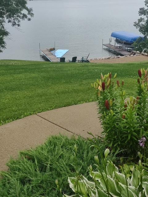 dock area featuring a water view and a yard