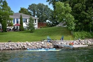 dock area with a yard and a water view