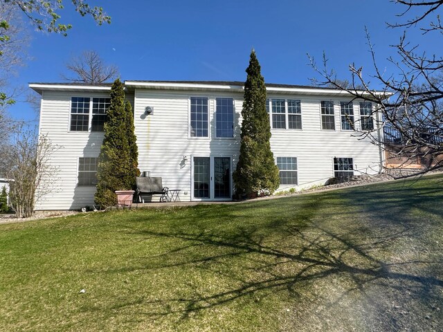 43561 Paul Lake Dr, Edna Twp, MN 56573 - rear view of house with a patio area and a lawn