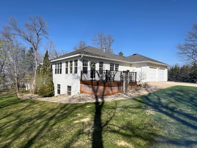 43561 Paul Lake Dr, Edna Twp, MN 56573 - view of front of house with a front yard, a wooden deck, an attached garage, and driveway