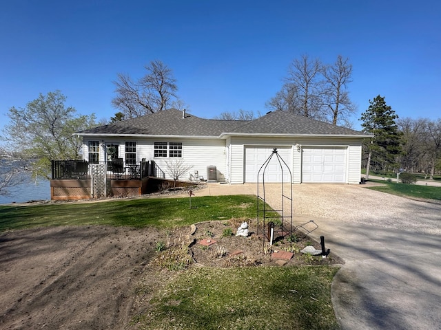 43561 Paul Lake Dr, Edna Twp, MN 56573 - exterior space featuring a lawn, dirt driveway, central air condition unit, a shingled roof, and a wooden deck