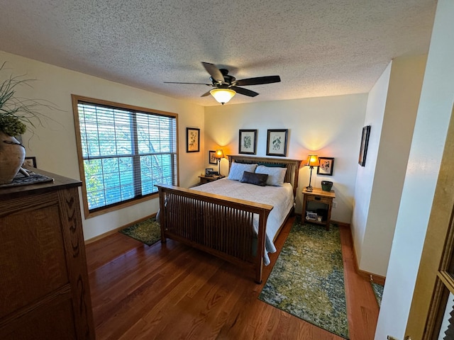 43561 Paul Lake Dr, Edna Twp, MN 56573 - bedroom with wood finished floors, a textured ceiling, ceiling fan, and baseboards