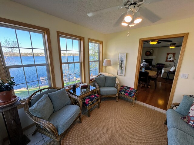 43561 Paul Lake Dr, Edna Twp, MN 56573 - living area with a water view, a ceiling fan, and a textured ceiling