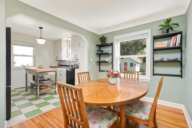 dining room featuring sink and light wood-type flooring