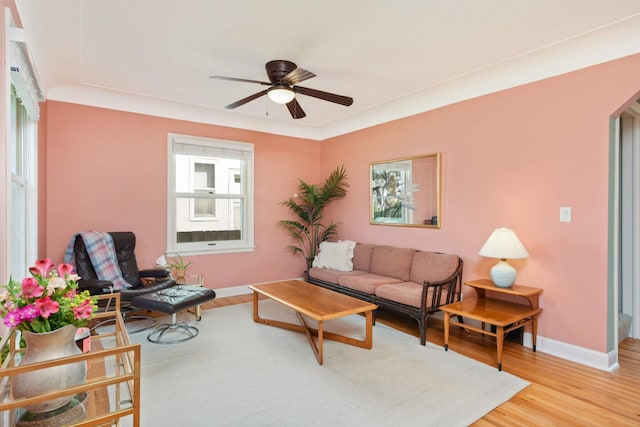 living room with hardwood / wood-style floors and ceiling fan